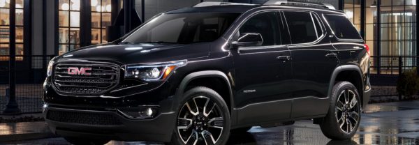 2019 GMC Acadia parked on street corner after dark