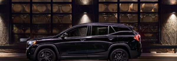 Black 2019 GMC Terrain parked in front of distillery