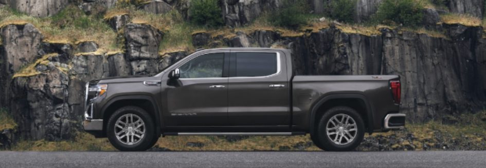 A 2019 GMC Sierra 1500 parked in front of a mountain